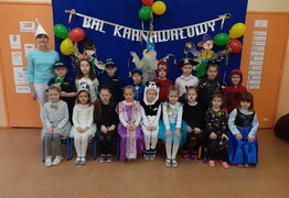 Dzieci z grupy Pracusie (Borówko Stare) na zdjęciu grupowym podczas balu karnawałowego. Dzieci są przebrane w stroje karnawałowe. W tle kolorowa dekoracja. Po lewej p. Ela (photo)
